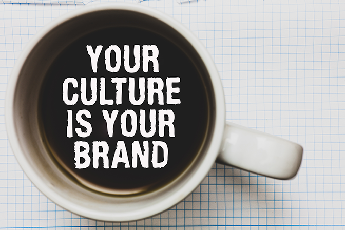 Looking down into a coffee cup the words your culture is your brand float on the coffee